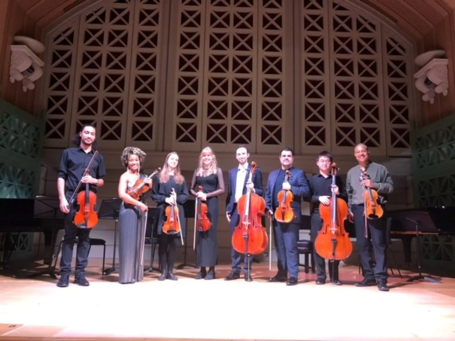 The Harlem Quartet and Royal College of Music musicians on stage after their string-octet performance